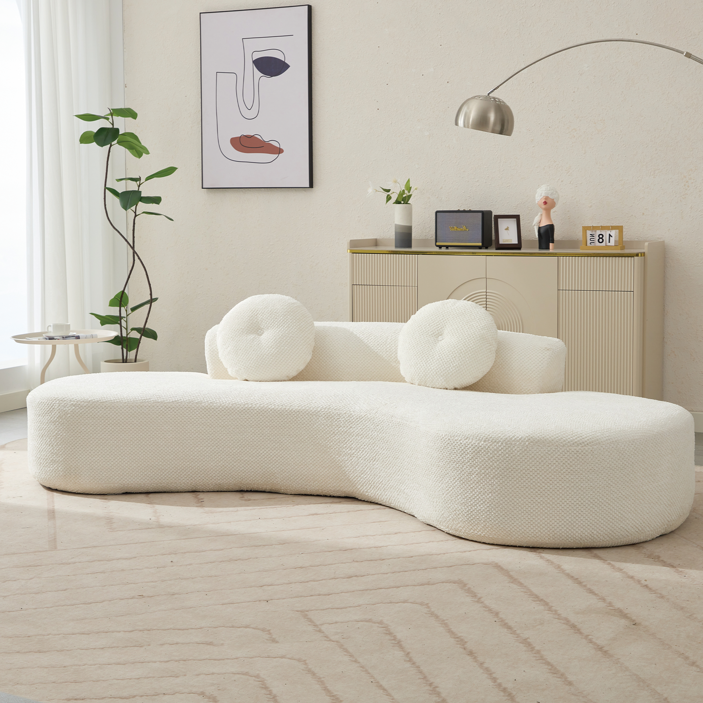 Textured ivory boucle sofa with curved design and round accent pillows for modern living rooms