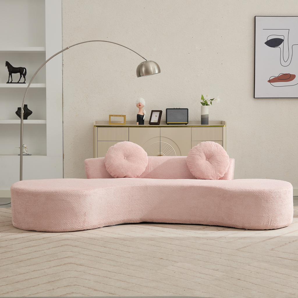 Curved blush pink boucle sofa with round throw pillows modern design