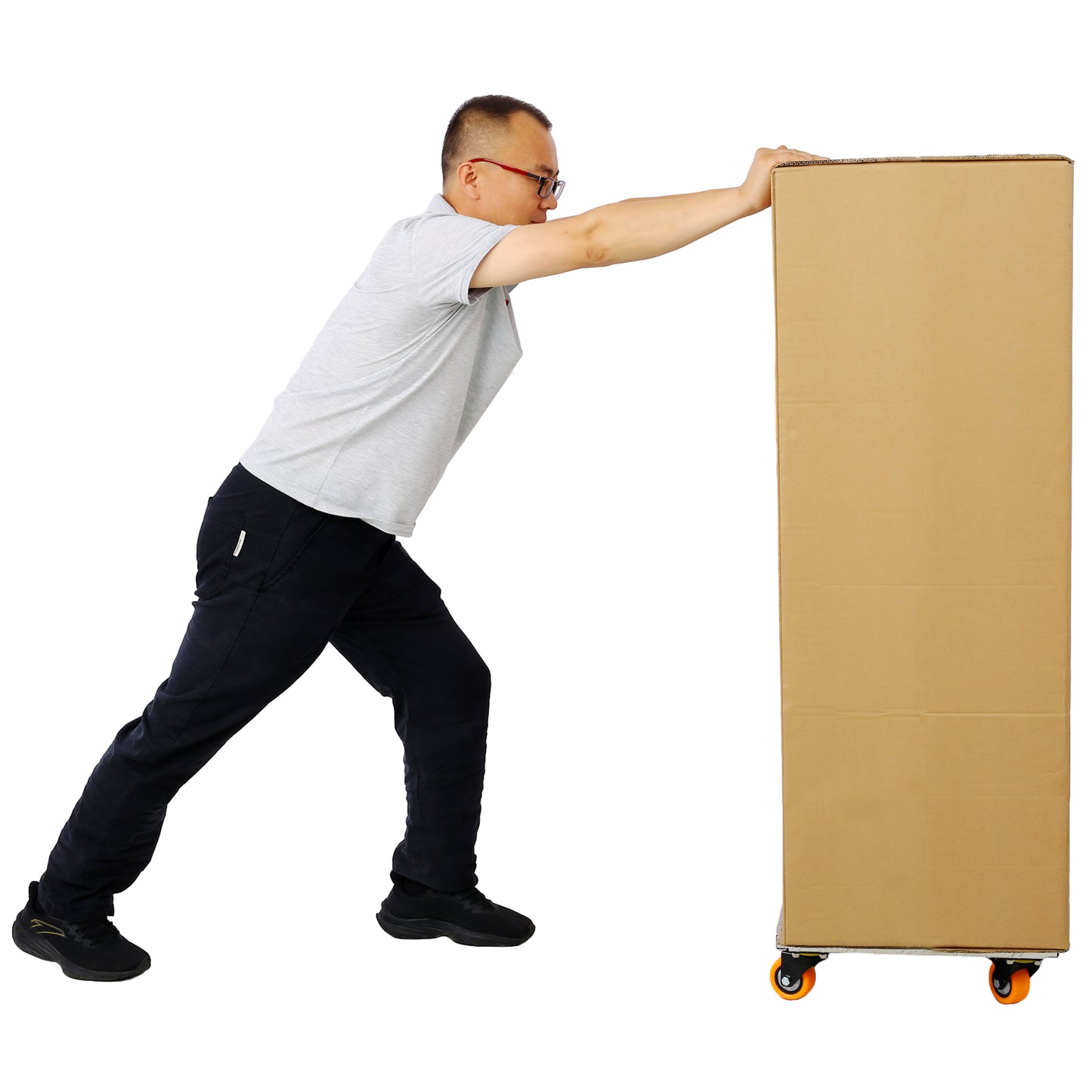 Man in grey shirt pushes tall cardboard box on wheeled dolly for moving and storage