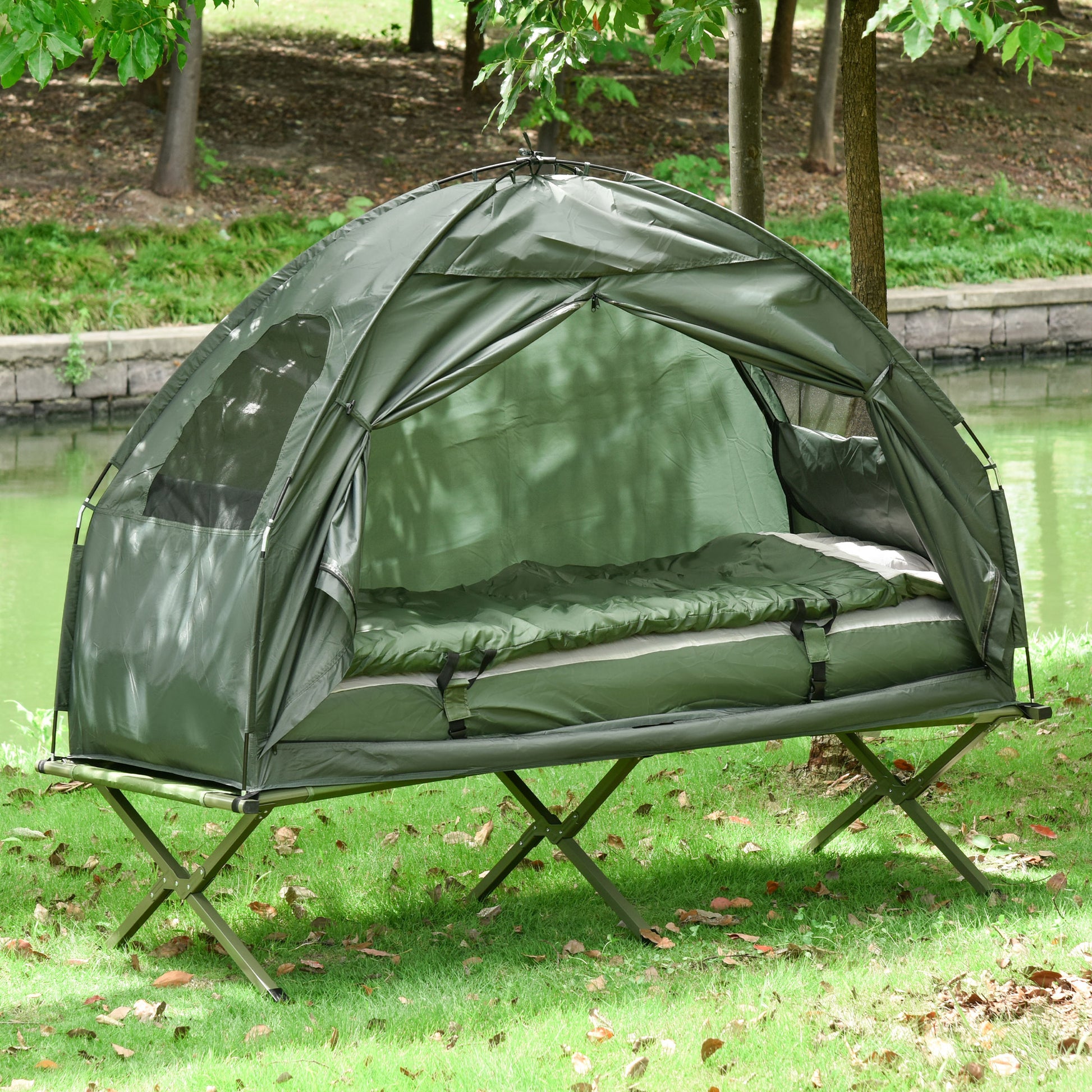 Green camping cot tent with sleeping bag elevated for outdoor comfort
