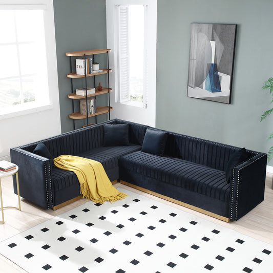 Navy blue velvet sectional sofa with gold base and decorative nailhead trim