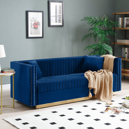 Deep blue velvet sofa with gold base and silver nailhead trim details