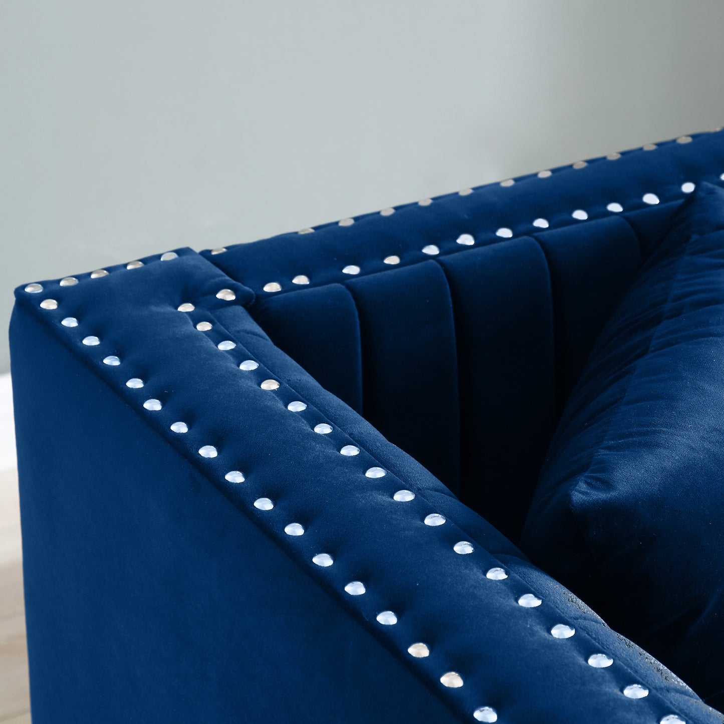 Deep blue velvet armchair with diamond tufting and silver nailhead trim