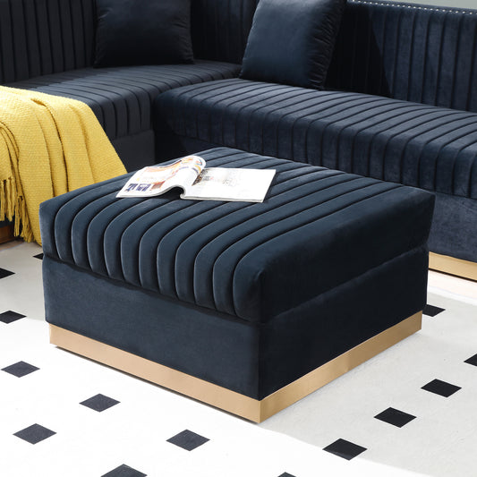 Deep navy velvet ottoman with channel tufting and gold base a chic accent piece