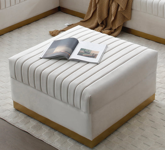 Cream velvet upholstered square ottoman with channel tufting and gold base