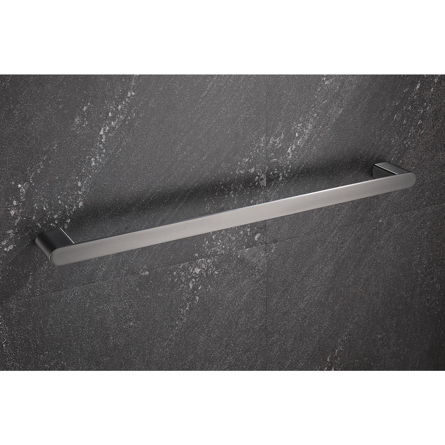 Brushed nickel single towel bar mounted on textured dark gray tile
