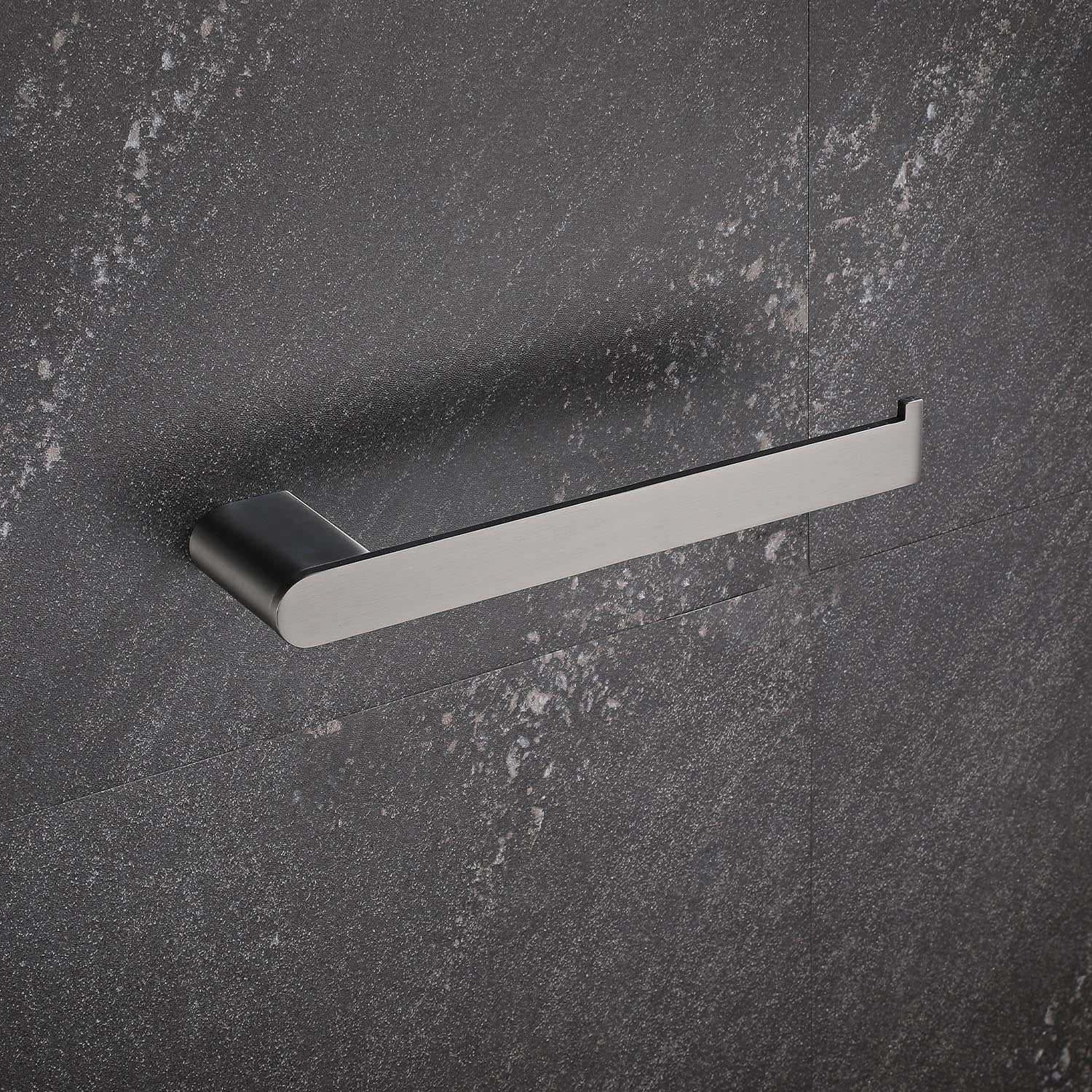 Sleek stainless steel toilet paper holder with a brushed finish on a dark textured wall