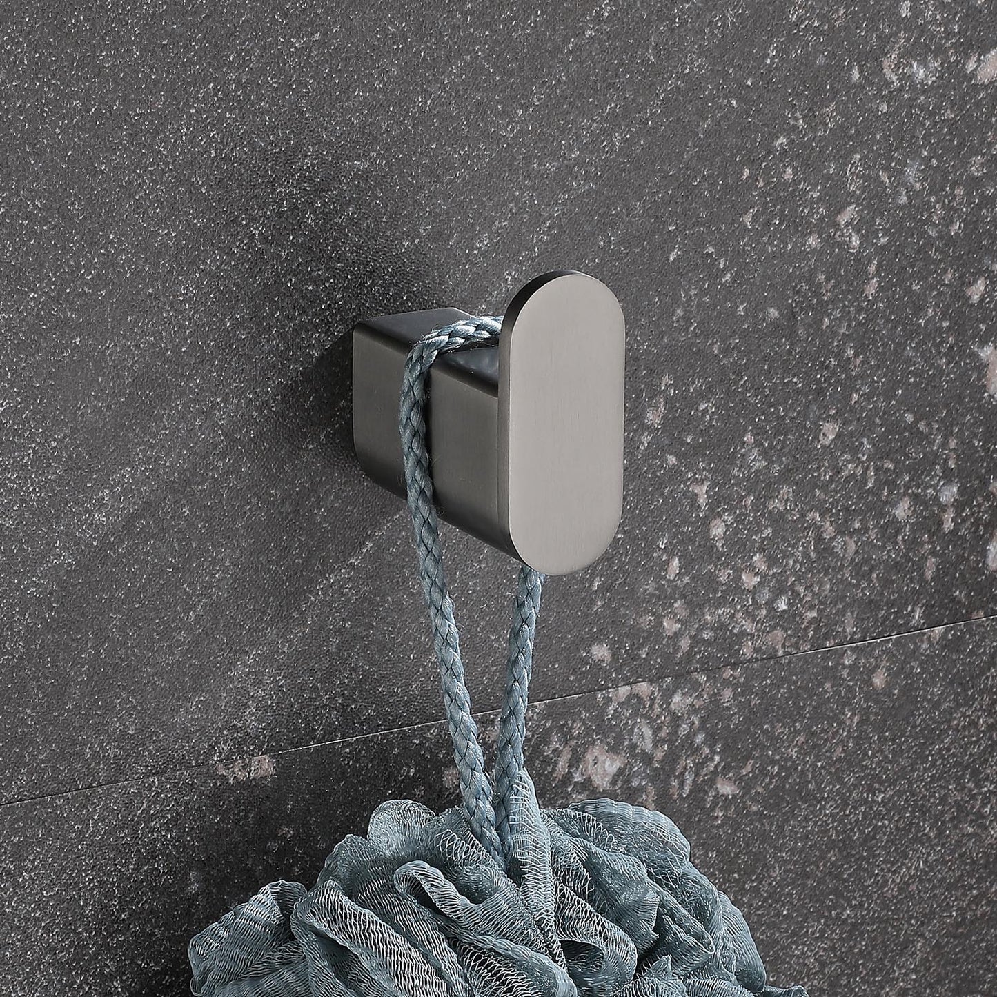 Brushed nickel bathroom hook holding a light blue loofah