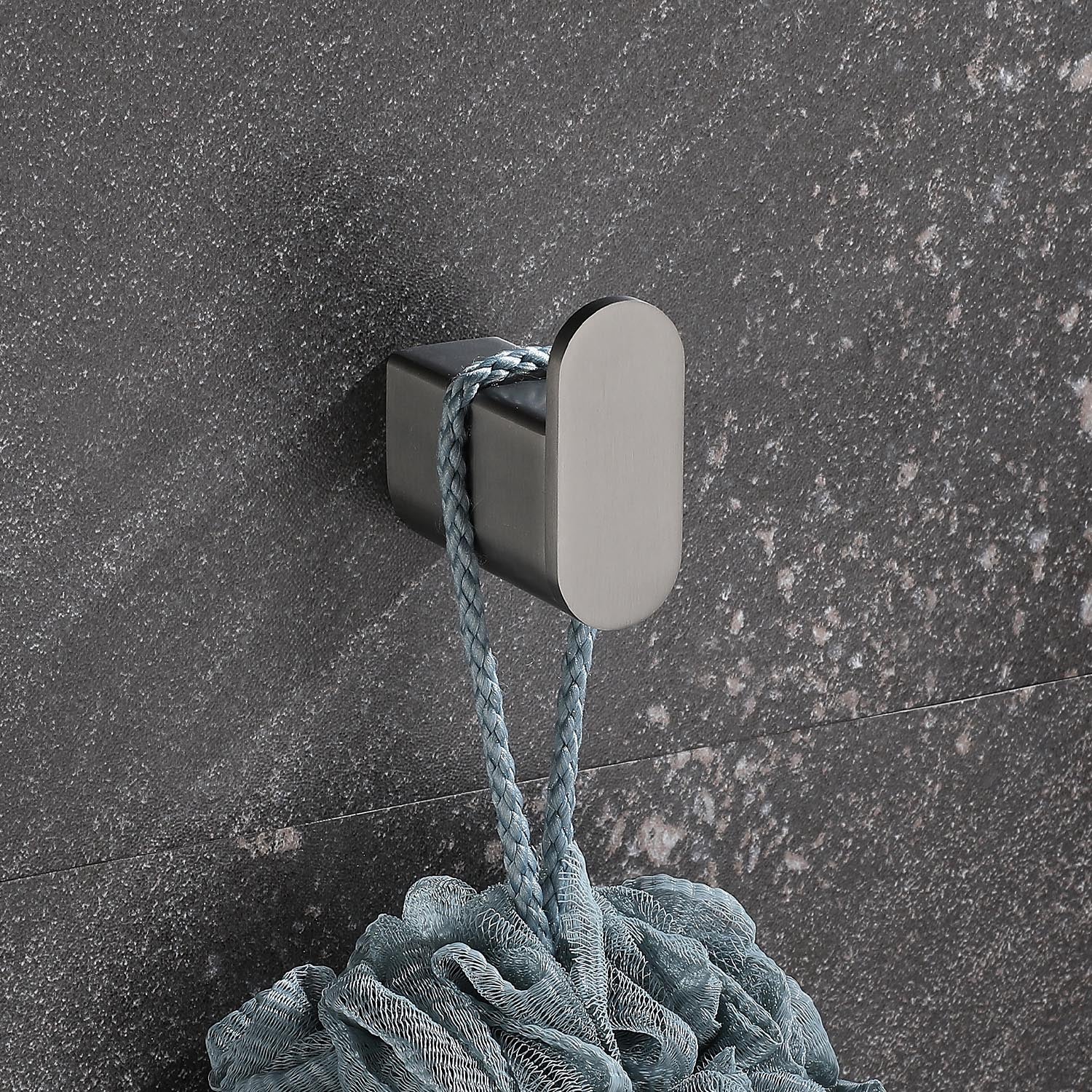 Brushed nickel bathroom hook holding a light blue loofah