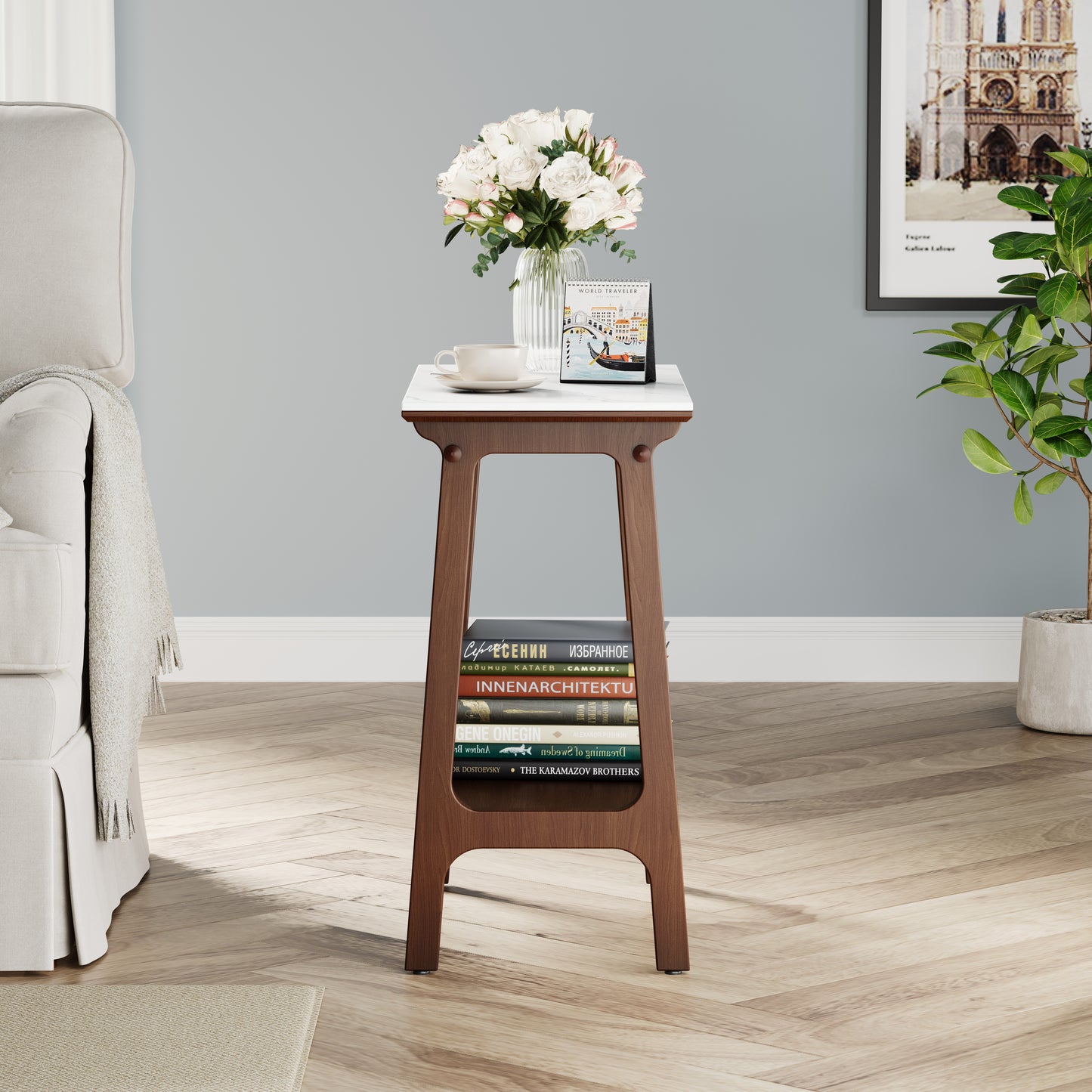 White marble top end table with dark wood legs and two shelves of books