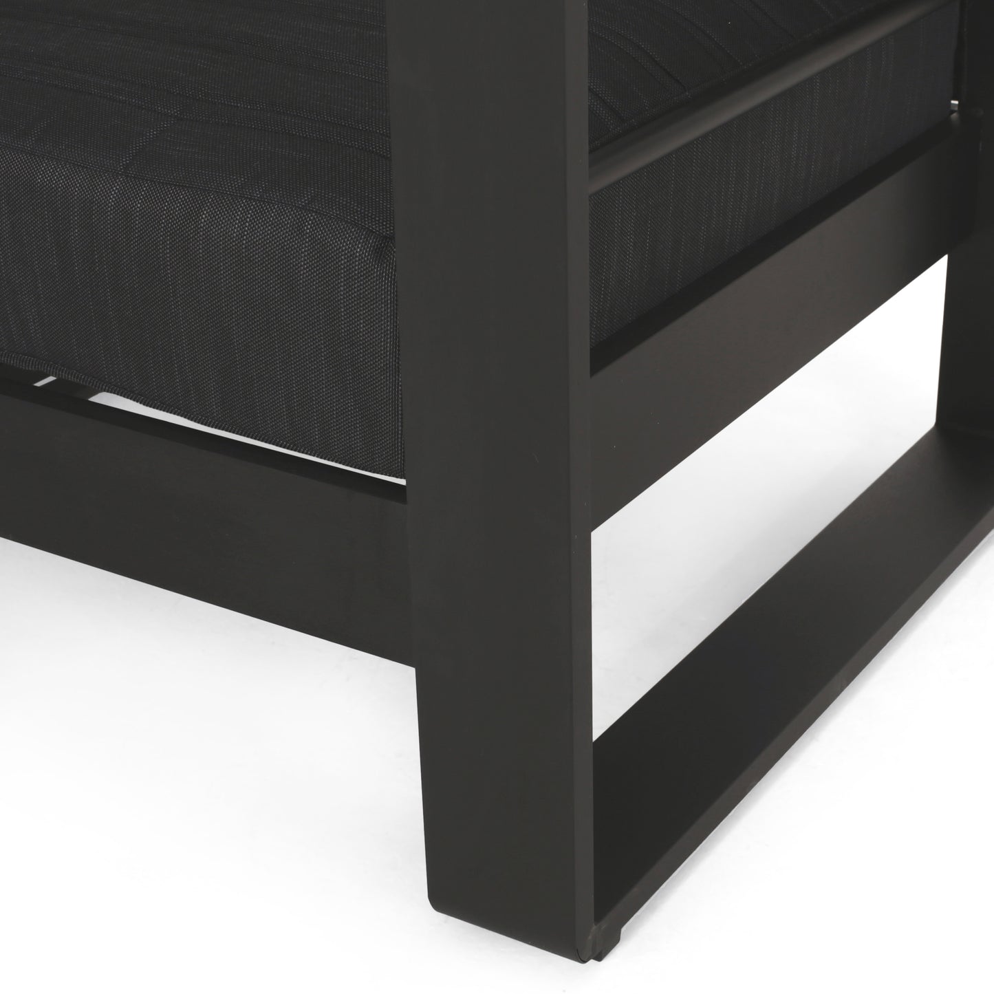 Closeup of black woven mesh seat on a modern outdoor chair frame