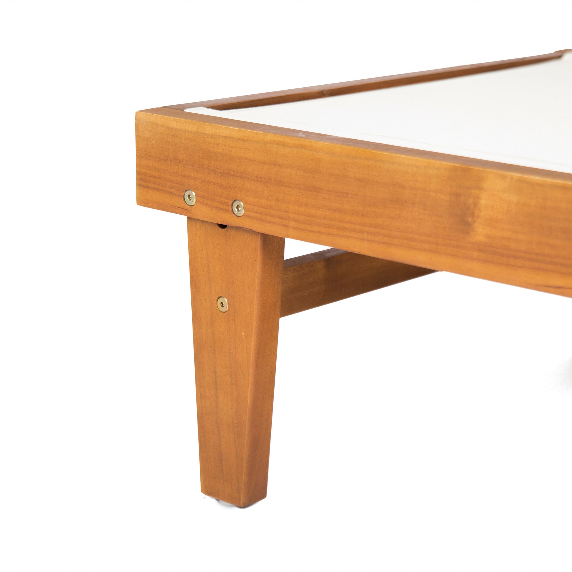 Close up of a light brown wooden outdoor lounge chair frame with white canvas seating detail