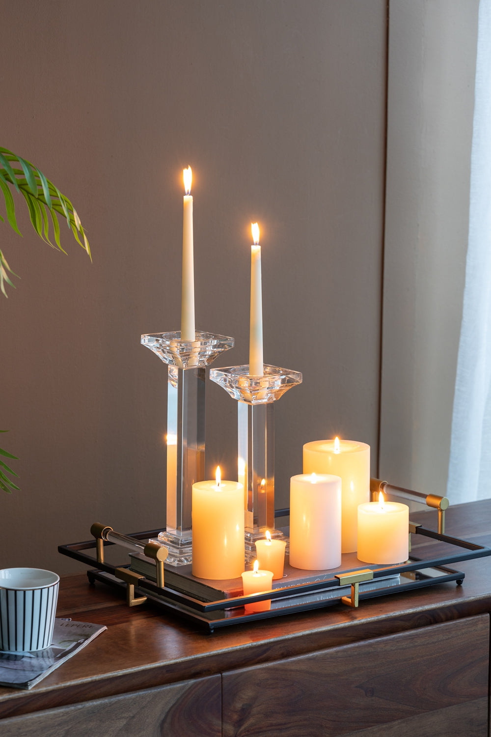 Set of five cream pillar candles and two tapered candles on crystal and mirrored tray