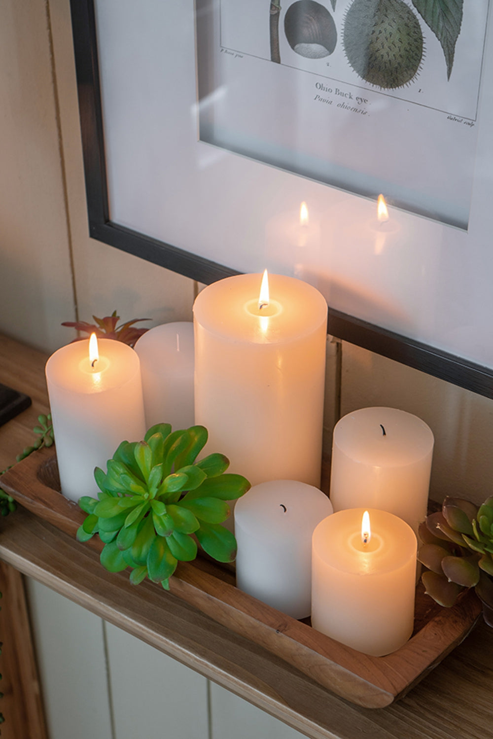 Set of six white pillar candles of varying heights creating a warm ambiance for relaxation