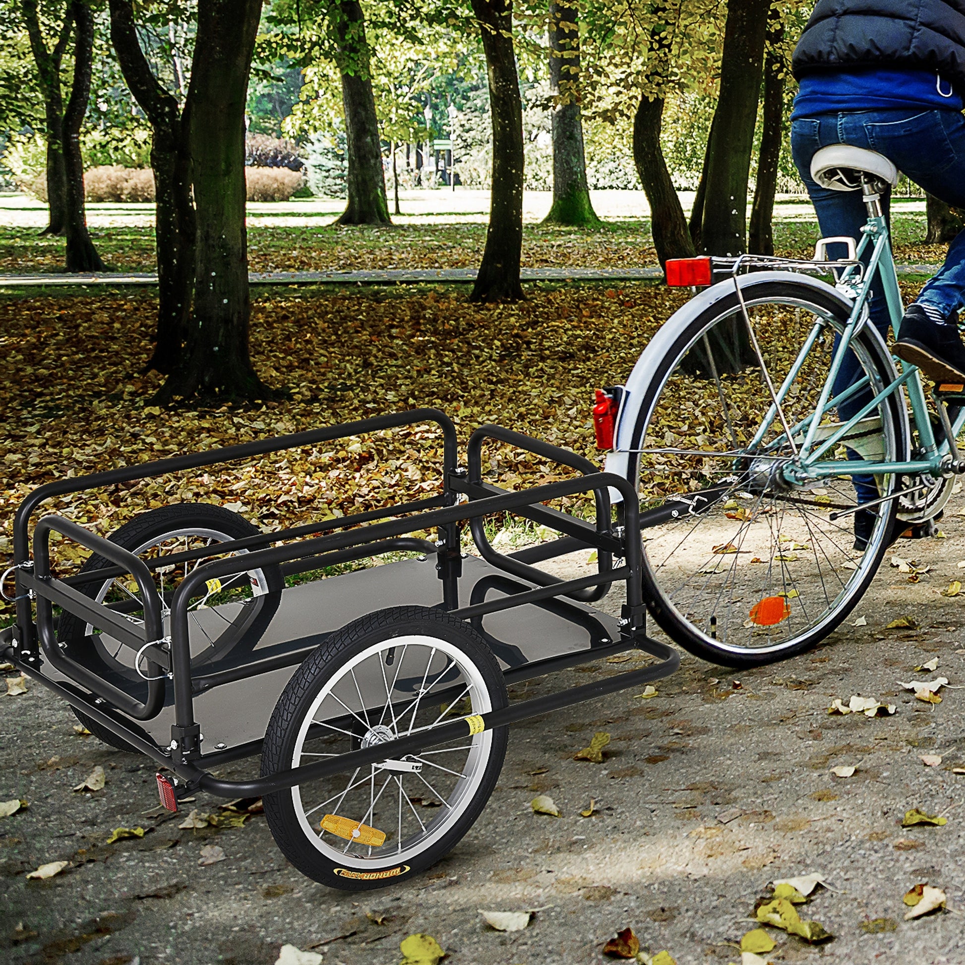 Black metal bicycle cargo trailer with dual wheels and reflective red taillight