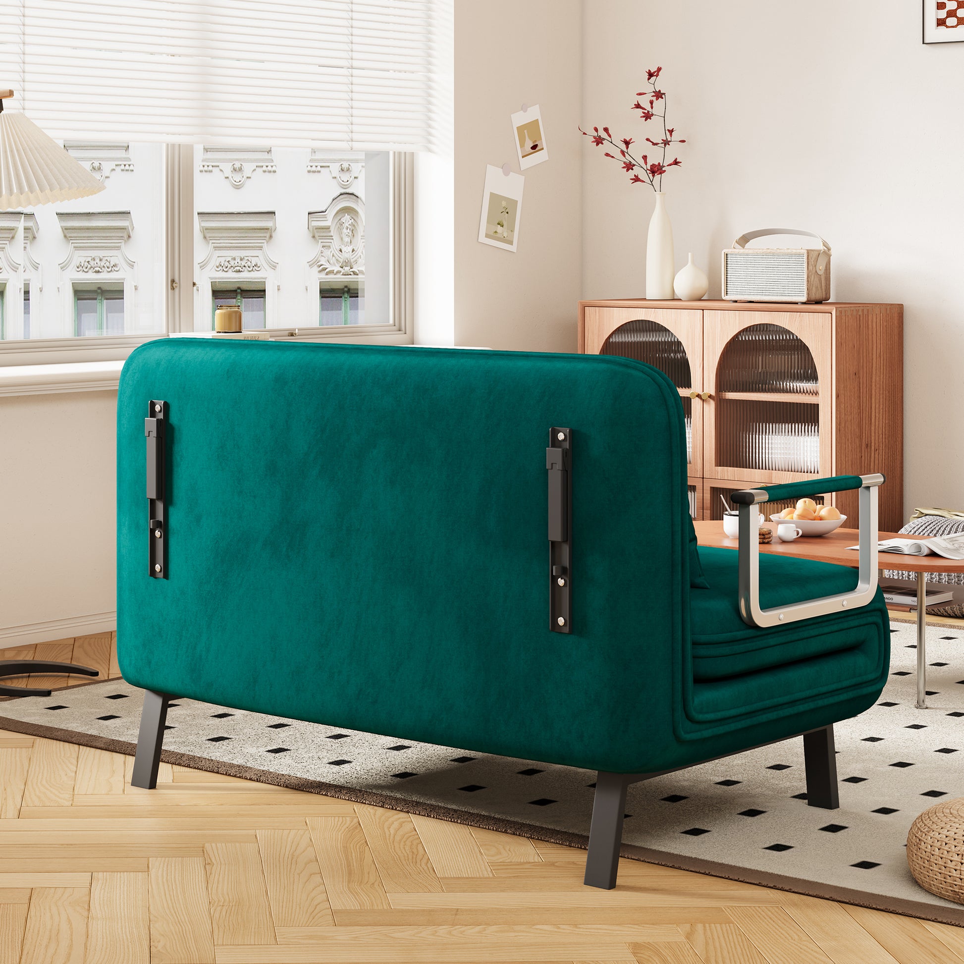 Deep emerald green velvet sofa with silver armrests ideal for modern living rooms