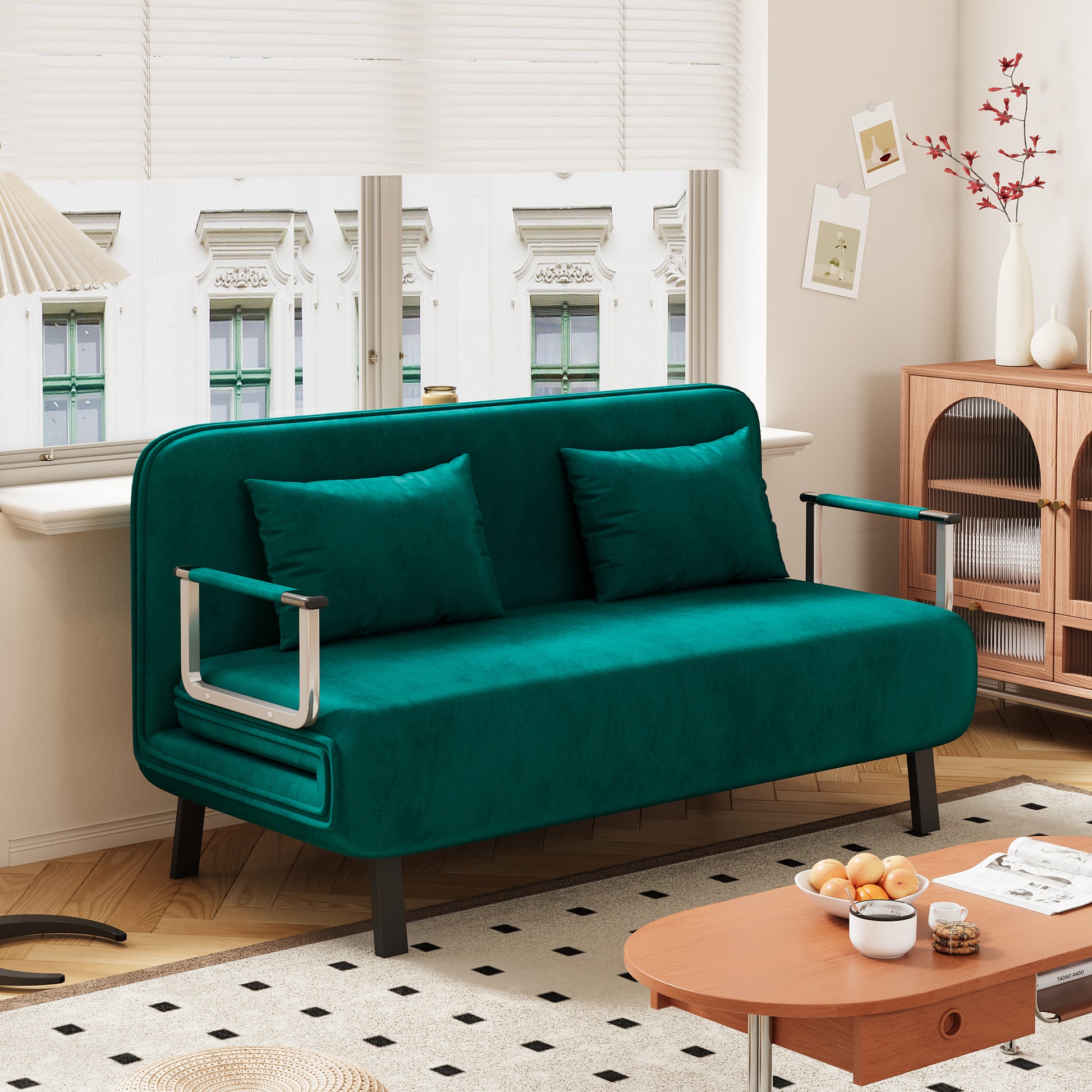 Plush velvet loveseat in deep teal with matching throw pillows and chrome accents
