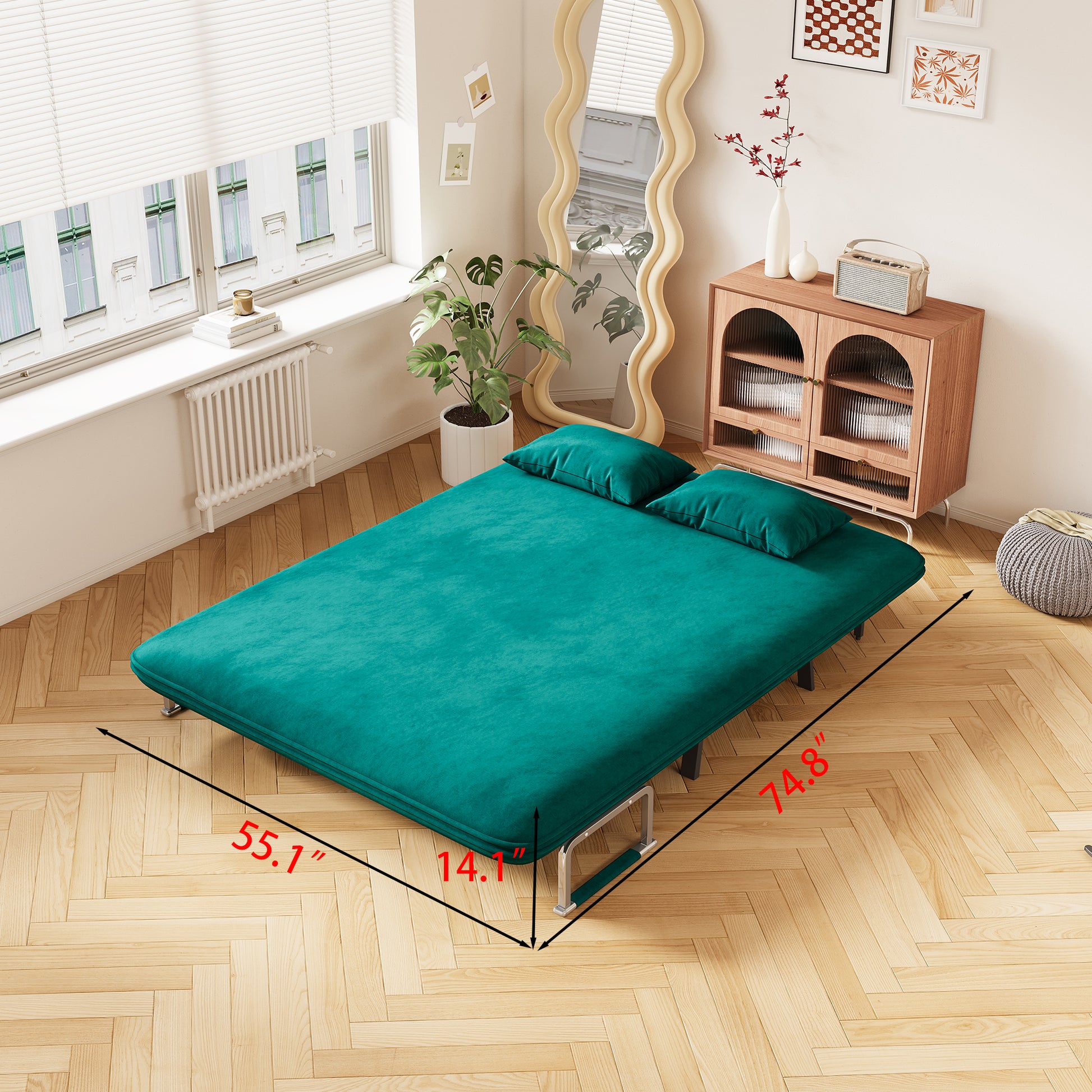 Teal velvet futon sofa bed with two matching pillows ideal for small spaces