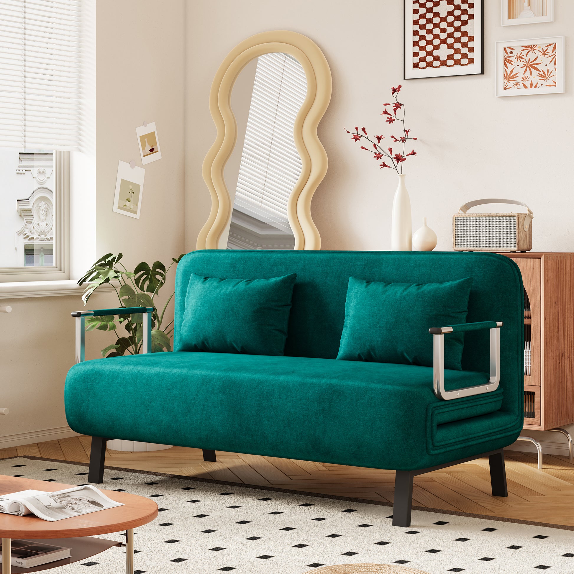 Teal velvet sofa with two matching throw pillows and sleek chrome arms