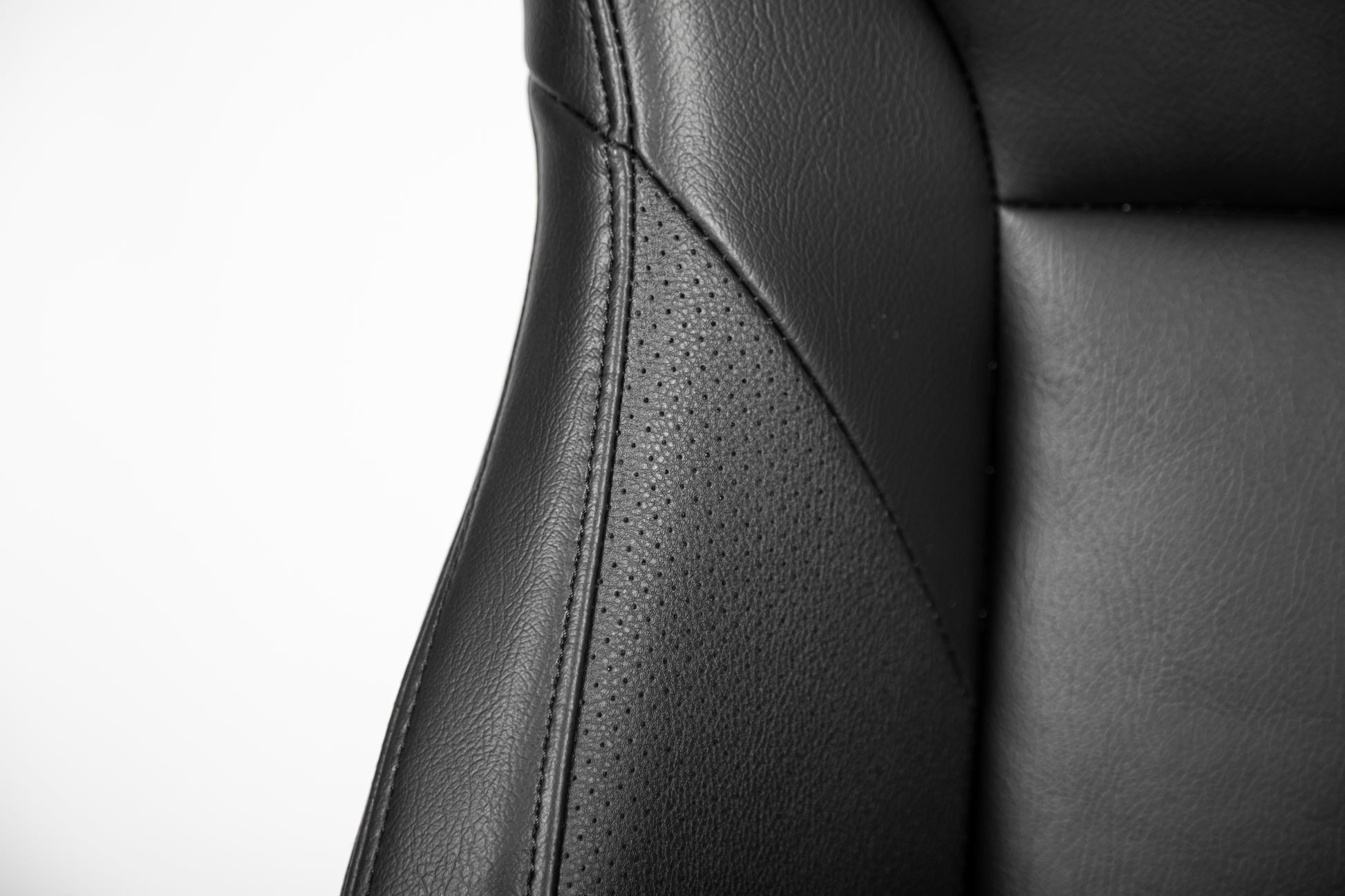 Black perforated leather seat detail with contrasting stitching