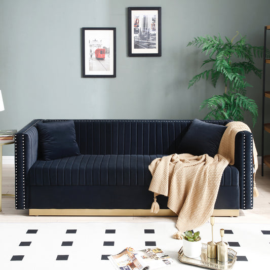 Navy velvet sofa with studded arms and plush cushions perfect for a modern living room
