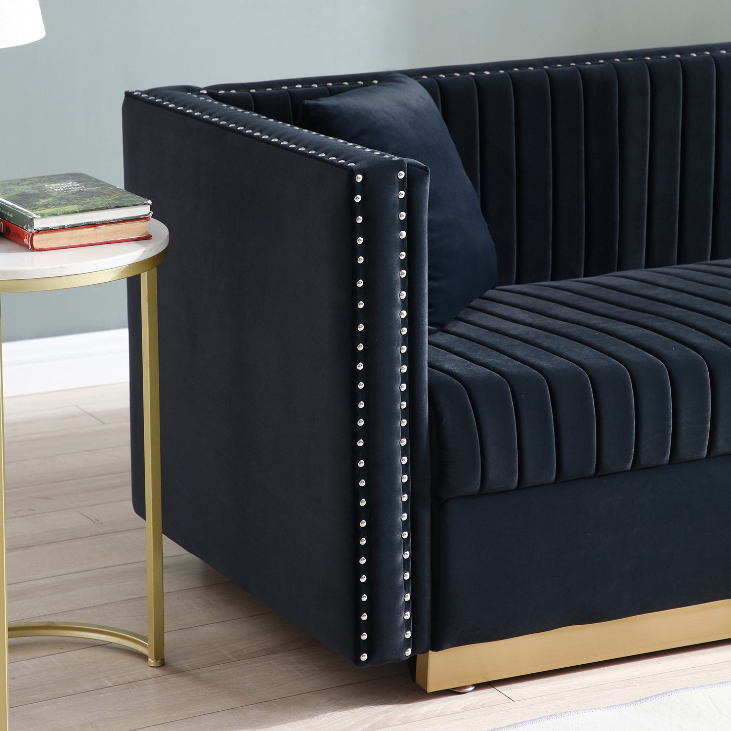 Elegant navy velvet sofa with channel tufting and silver nailhead trim accents