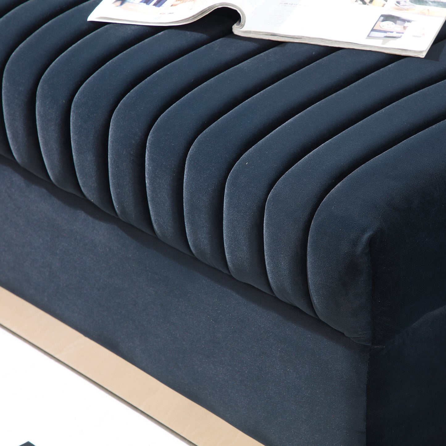 Dark navy velvet channel tufted bench with gold trim detail