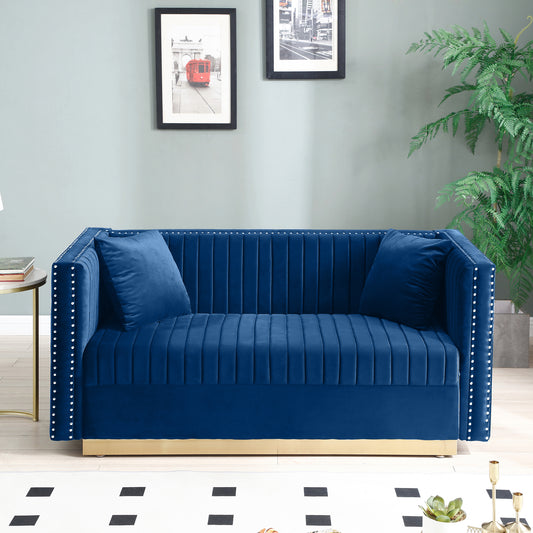 Deep blue velvet loveseat with tufted channels and silver nailhead trim