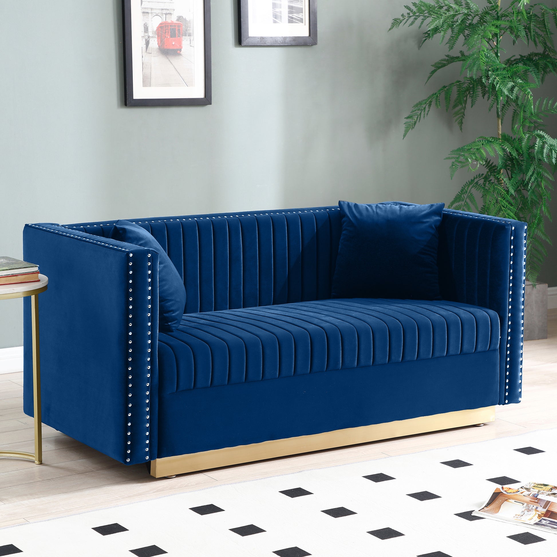 Navy blue velvet loveseat with button tufting and gold base
