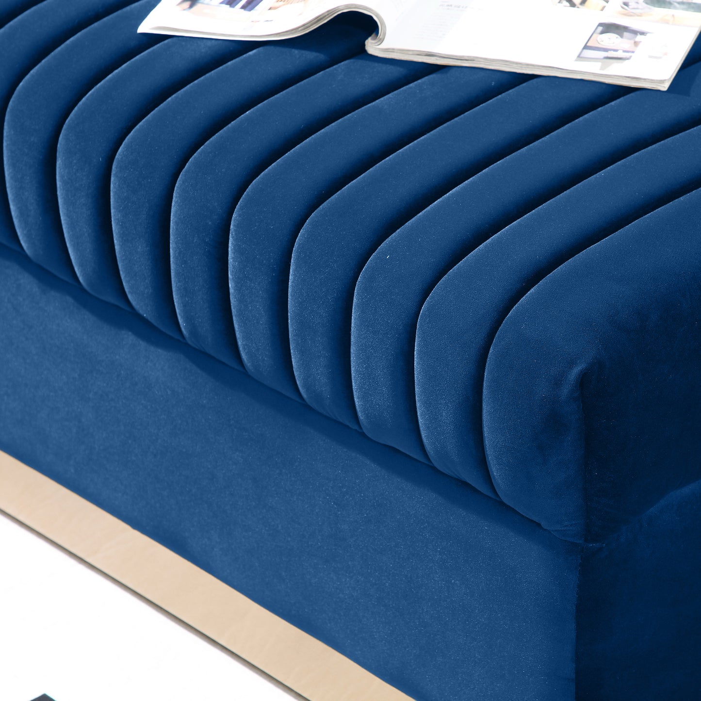 Plush blue velvet bench with channel tufting and a gold accent trim