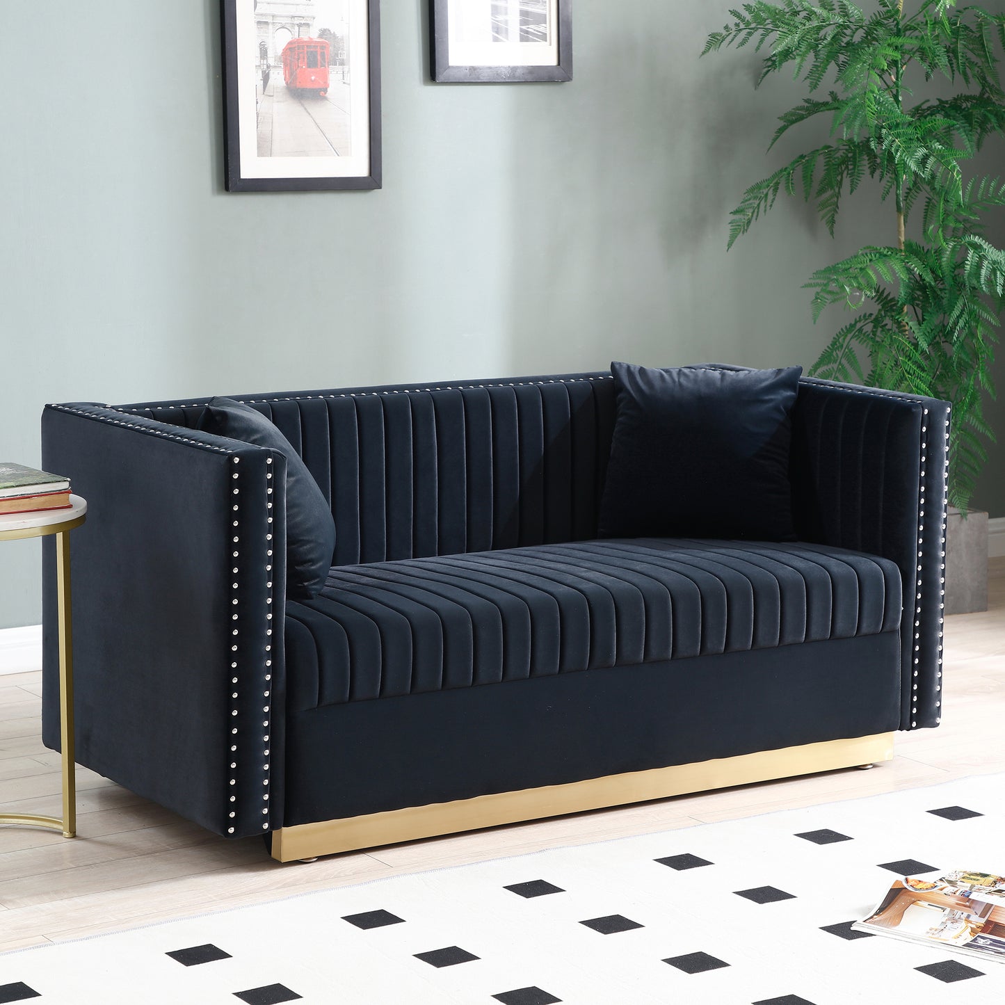 Navy velvet loveseat with channel tufting and brass base accented by silver nailhead trim