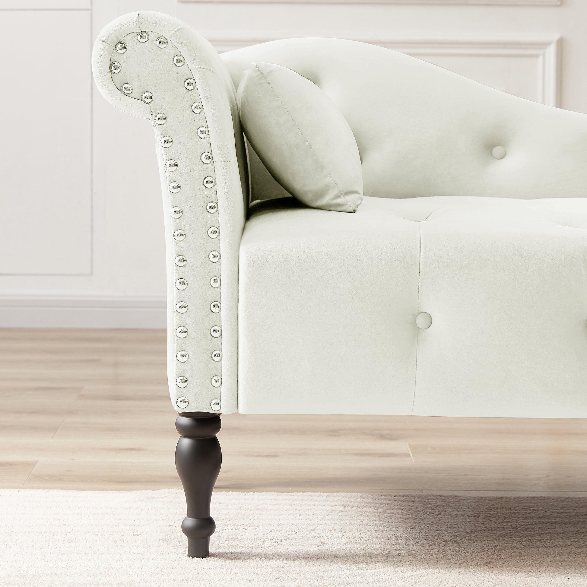 Elegant cream velvet chaise lounge with silver nailhead trim and dark wood legs