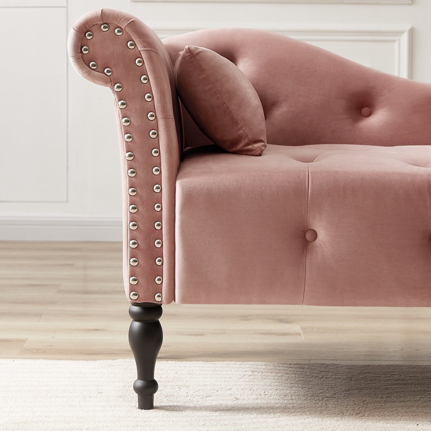 Plush pink velvet chaise lounge with silver nailhead trim and tufted details