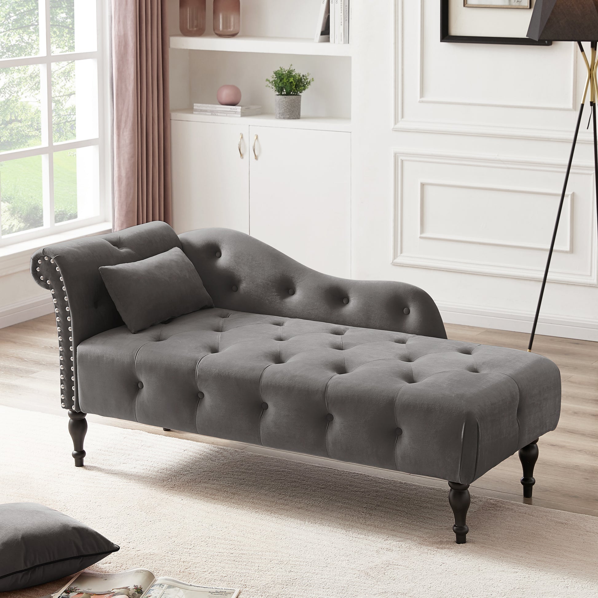 Grey velvet chaise lounge with tufted seat and studded arms
