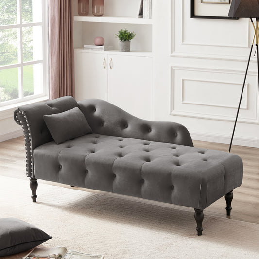 Grey velvet chaise lounge with tufted seat and studded arms
