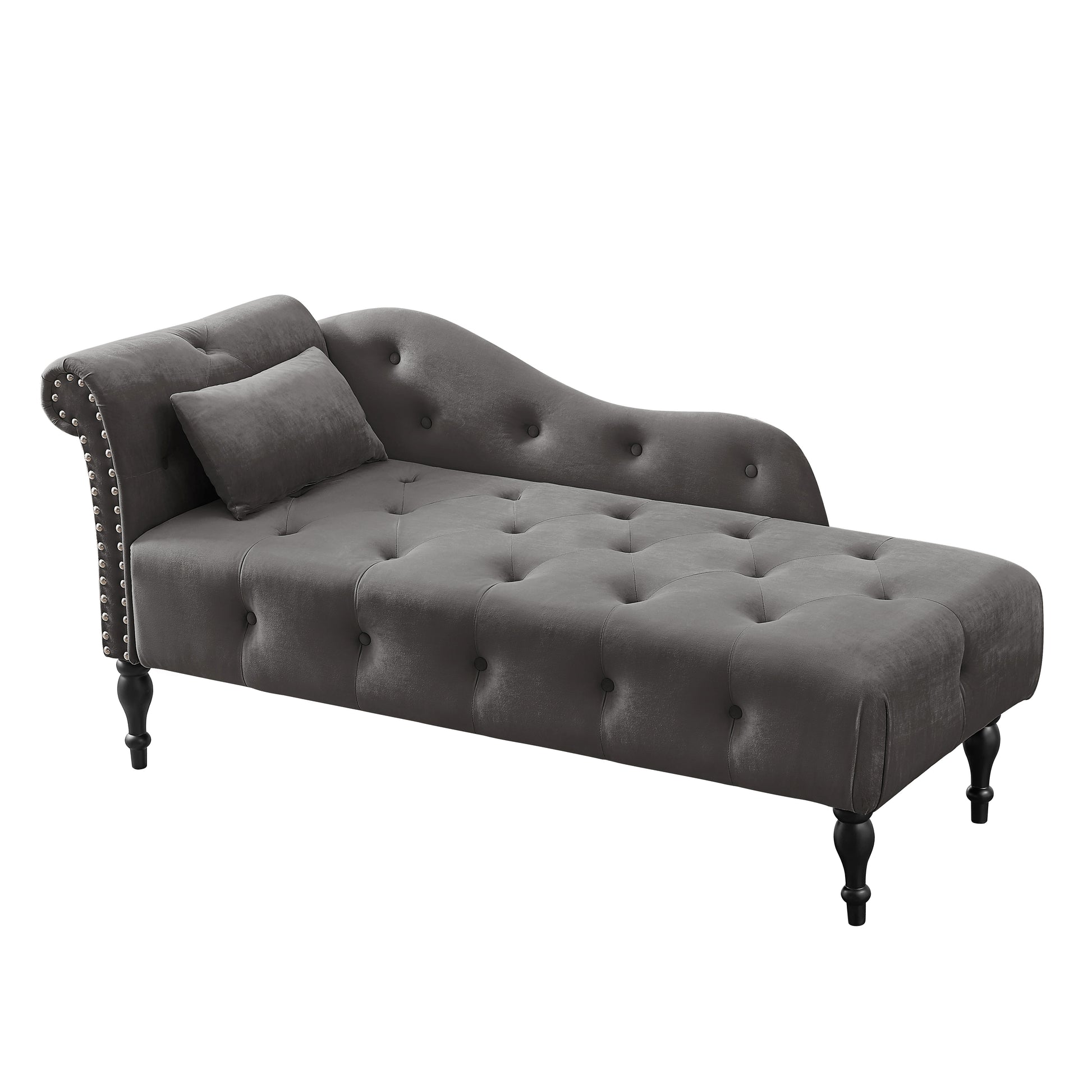 Tufted grey velvet chaise lounge with silver nailhead trim and a decorative pillow