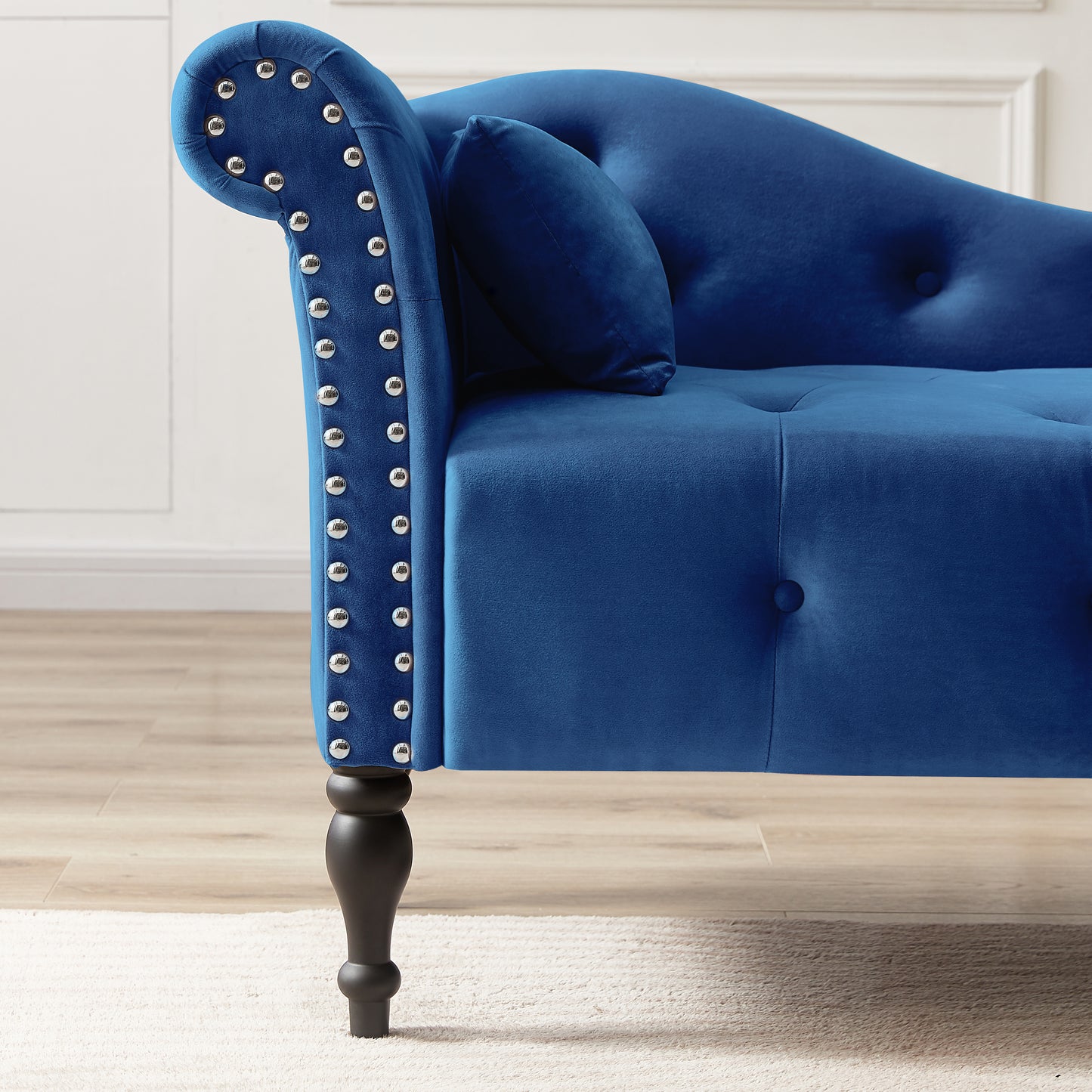 Deep blue velvet chaise lounge with silver nailhead trim and tufted details