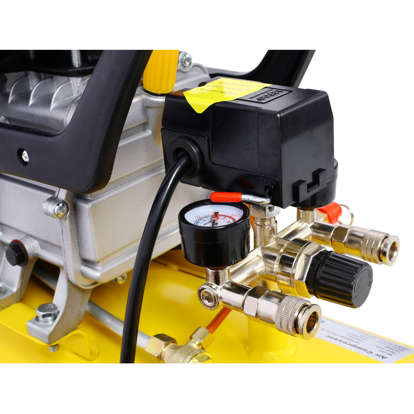 Closeup of a yellow air compressors pressure gauge and brass fittings