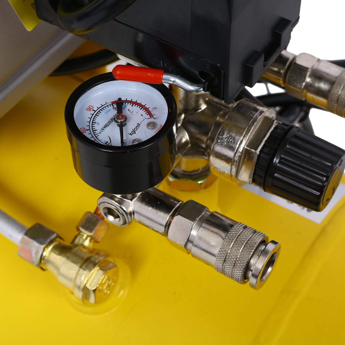 Yellow air compressor pressure gauge with black dial and red lever for precise PSI readings
