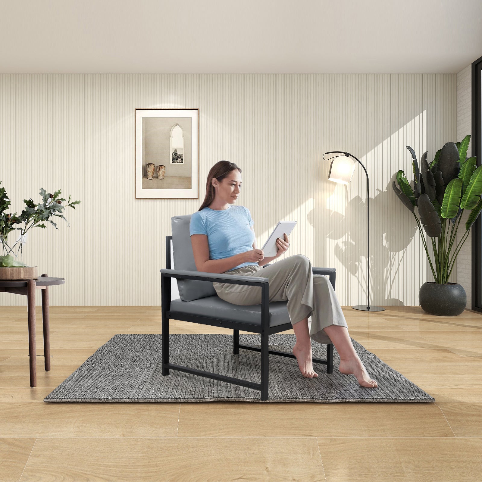 Modern grey armchair with black metal frame perfect for living rooms
