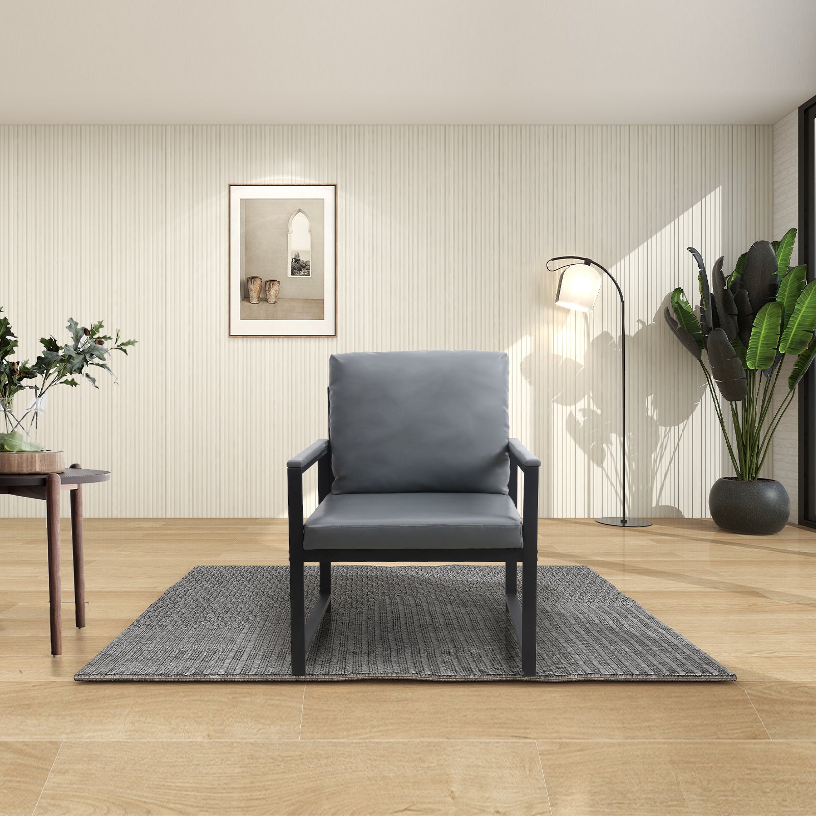Gray upholstered armchair with black metal frame on a textured rug