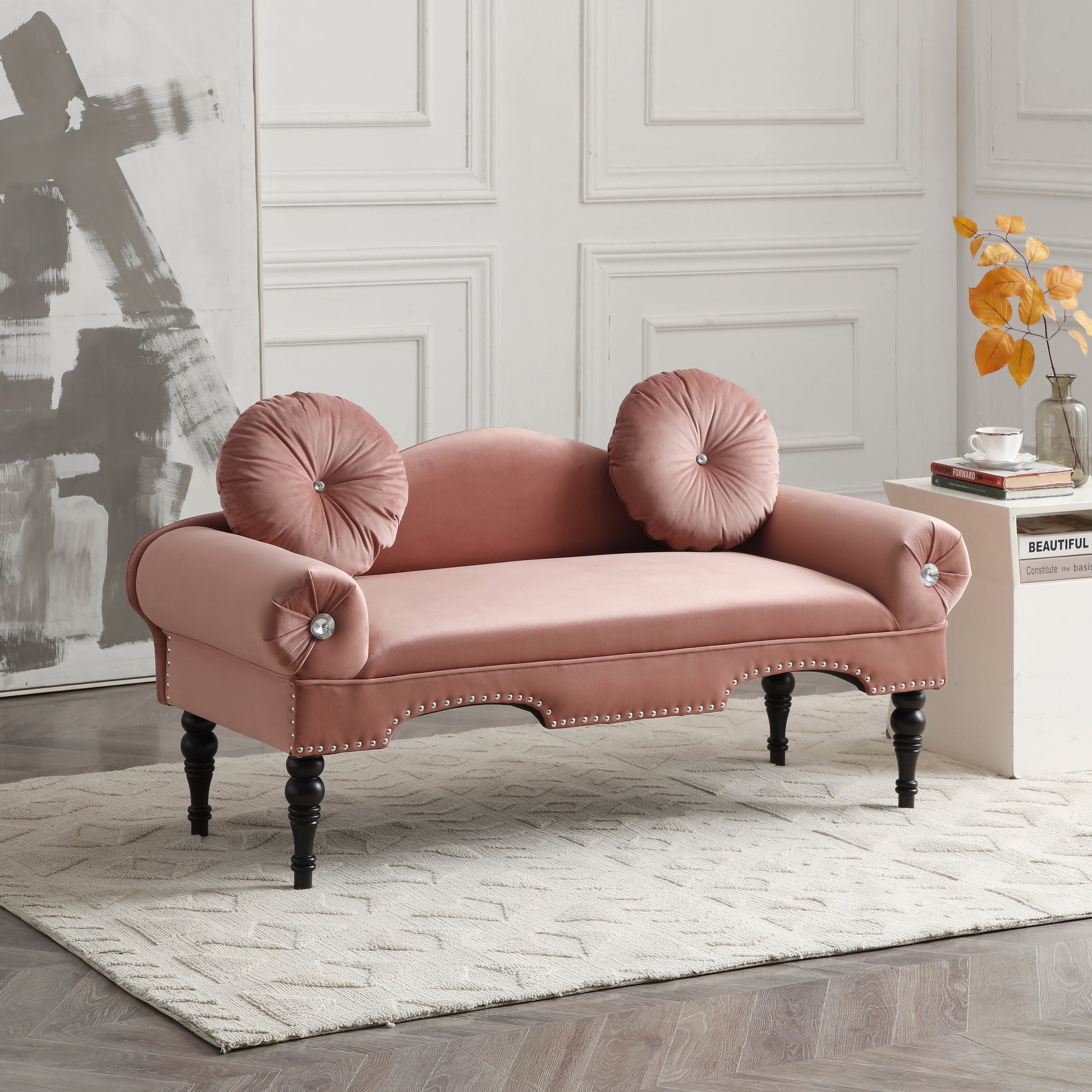 Dusty rose velvet loveseat with ornate silver nailhead trim and tufted round throw pillows