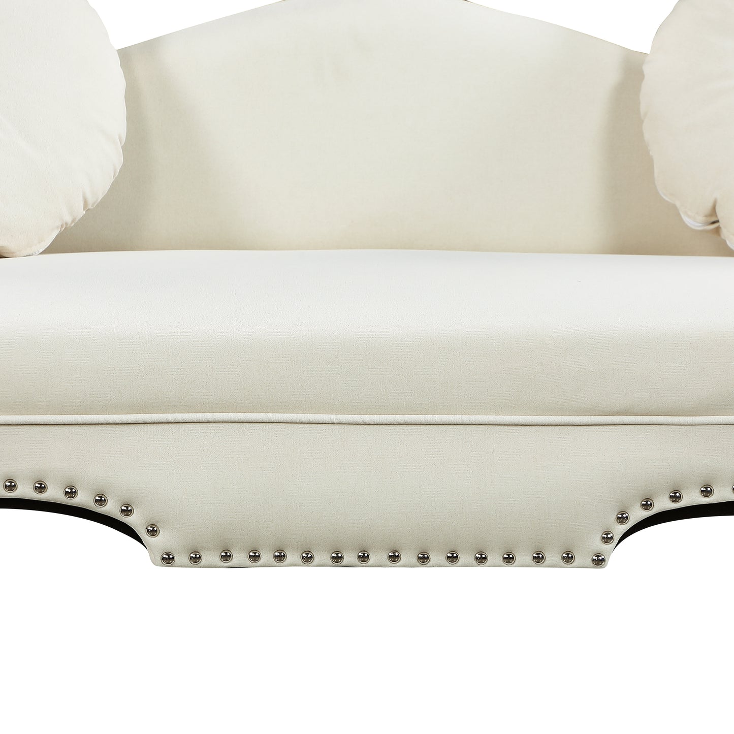 Cream tufted loveseat with decorative silver nailhead trim and round throw pillows