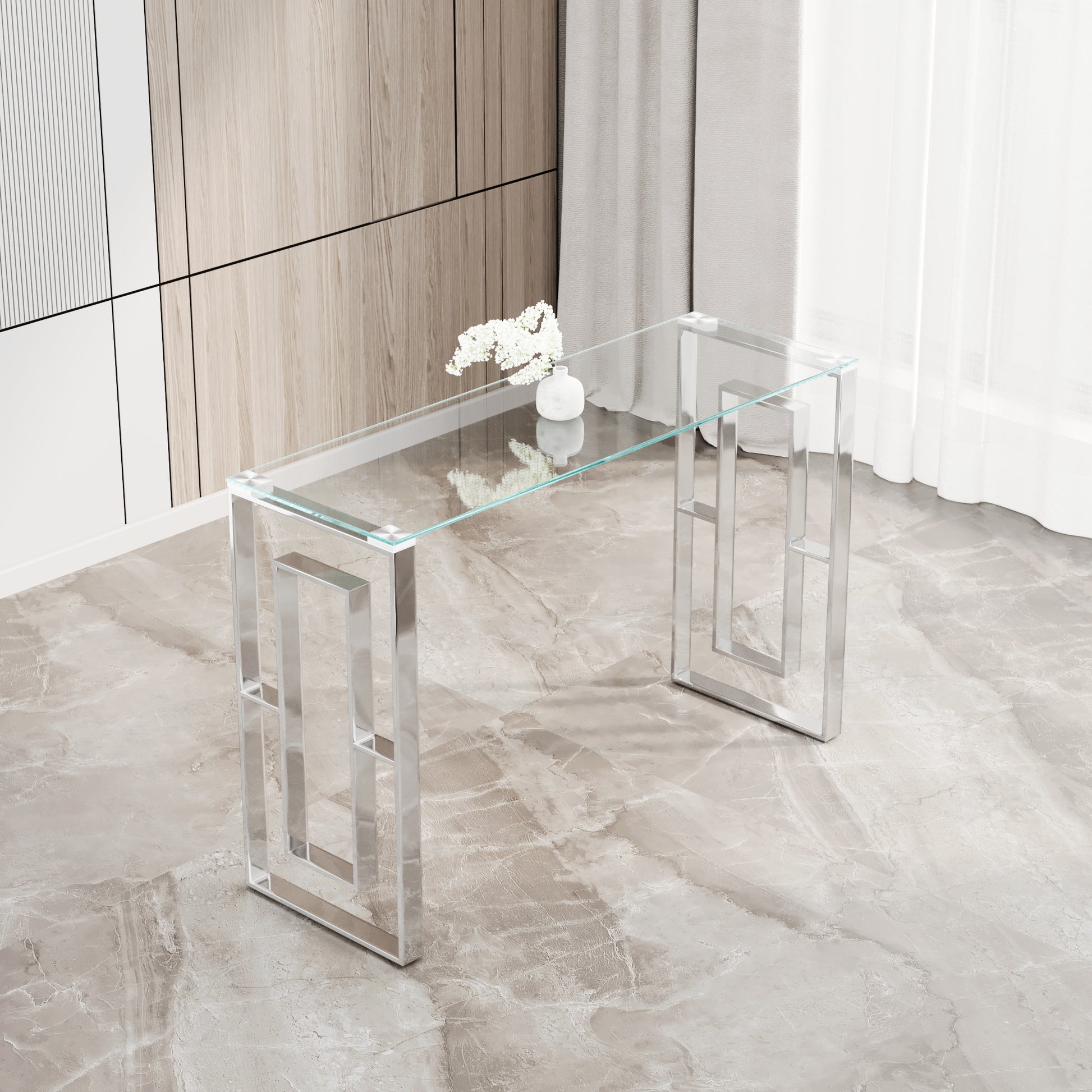 Sleek modern console table with clear glass top and polished chrome geometric legs