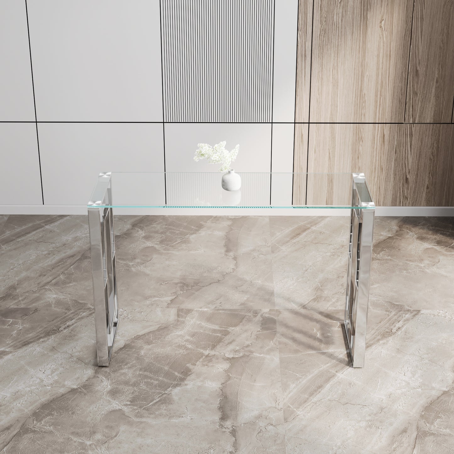 Clear glass console table with polished chrome legs and geometric detailing