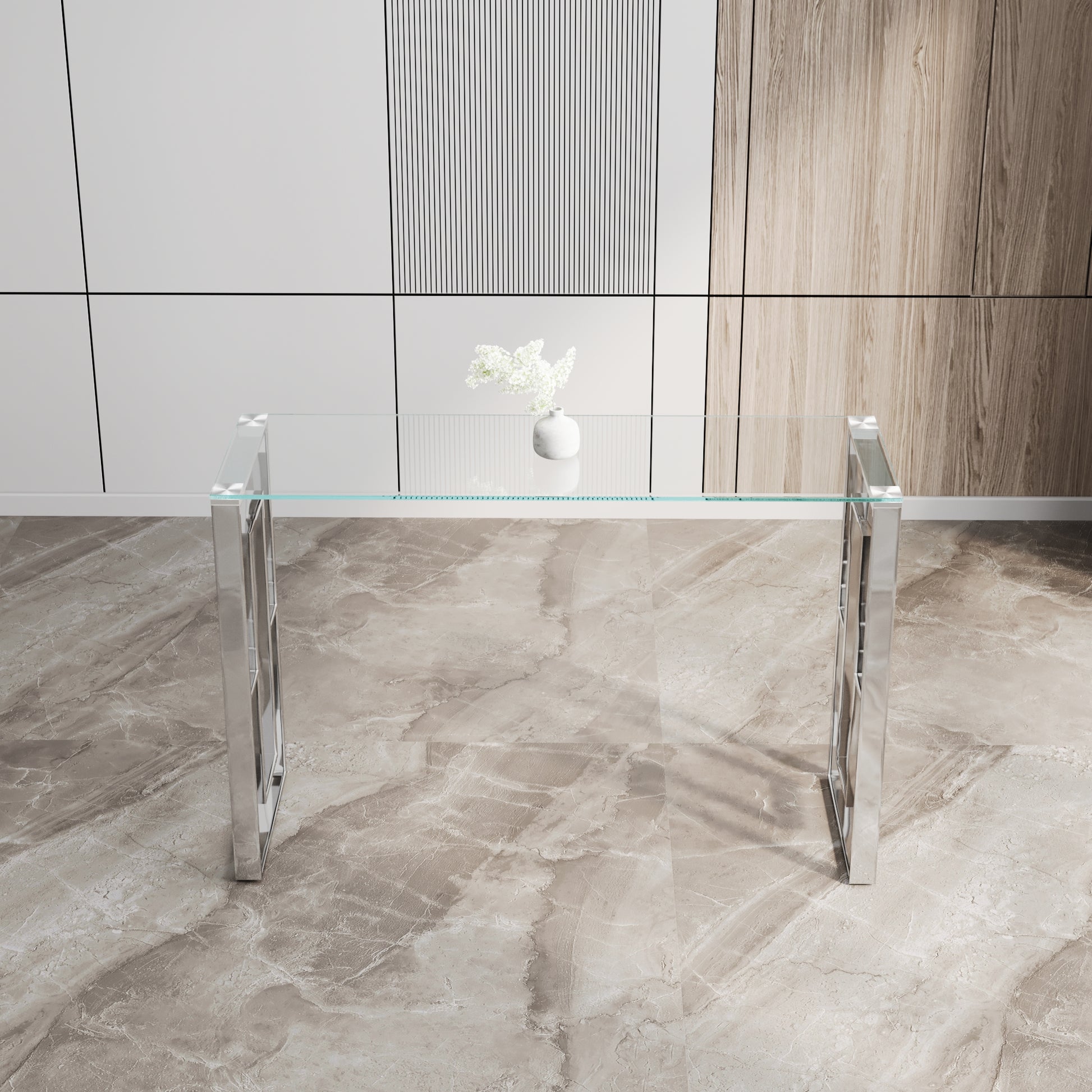 Clear glass console table with polished chrome legs and geometric detailing