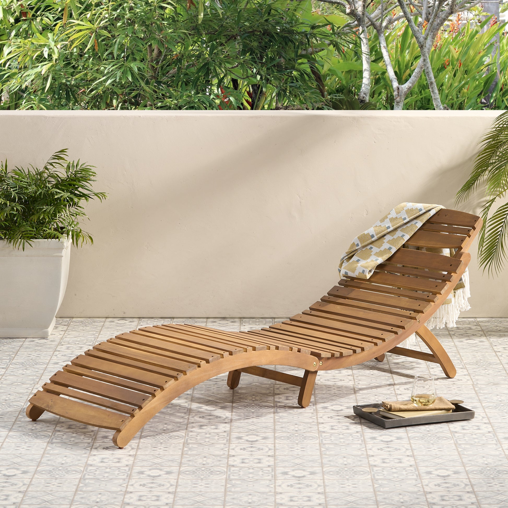 Curved natural wood lounger with slatted design perfect for outdoor relaxation