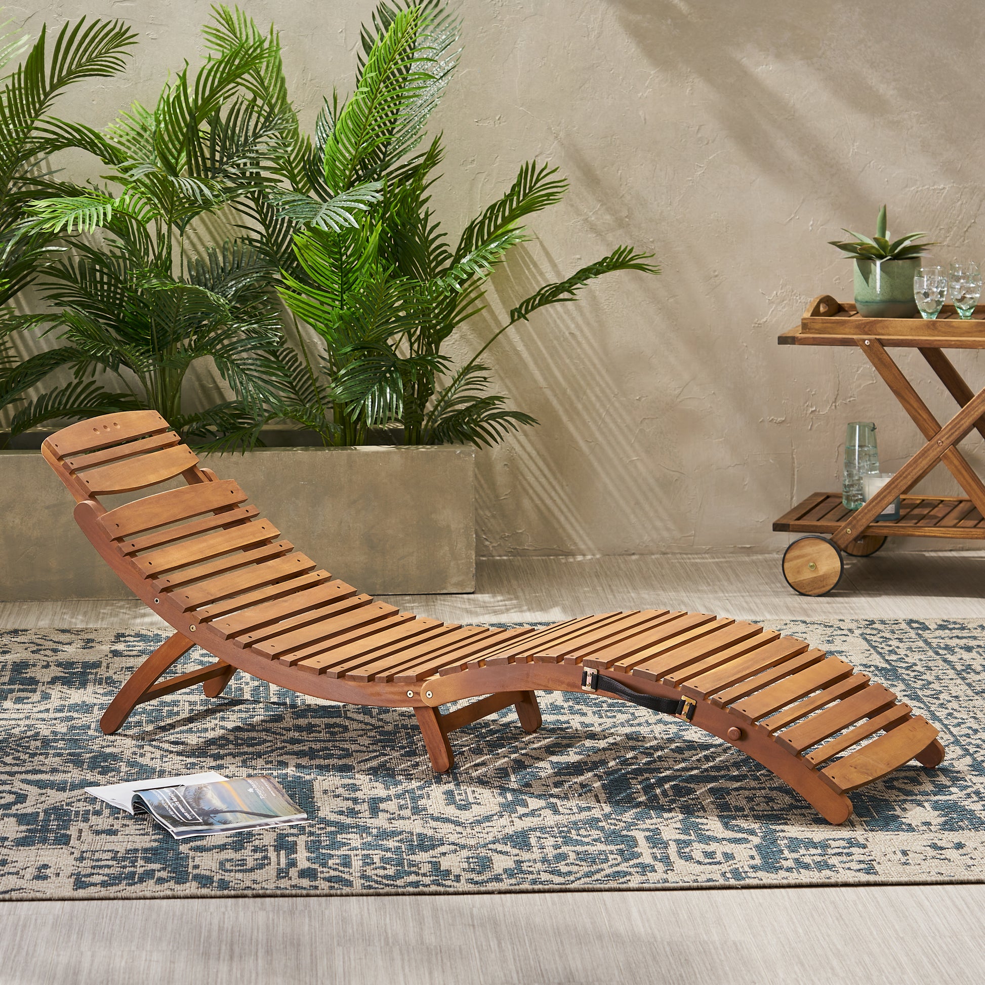 Wooden adjustable chaise lounge chair on a patterned rug