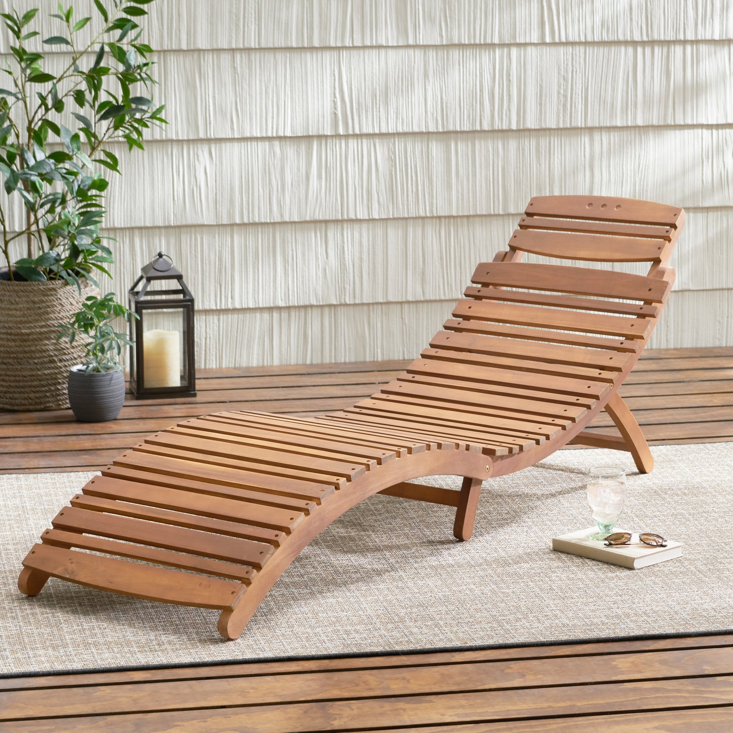Wooden adjustable chaise lounge with slatted design for outdoor relaxation