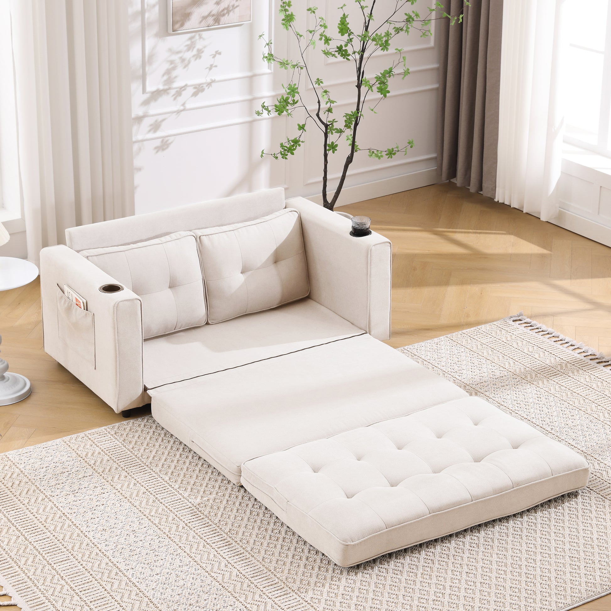 Cream upholstered sofa bed with tufted cushions and pullout ottoman